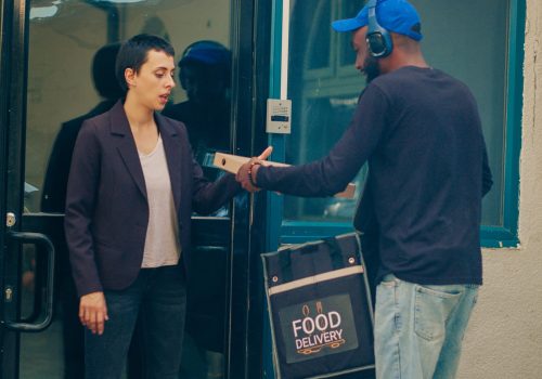 african-american-carrier-ringing-door-bell-deliver-fastfood-meal-order-carrying-takeaway-backpack-restaurant-courier-delivering-lunch-food-customer-office-building-handheld-shot